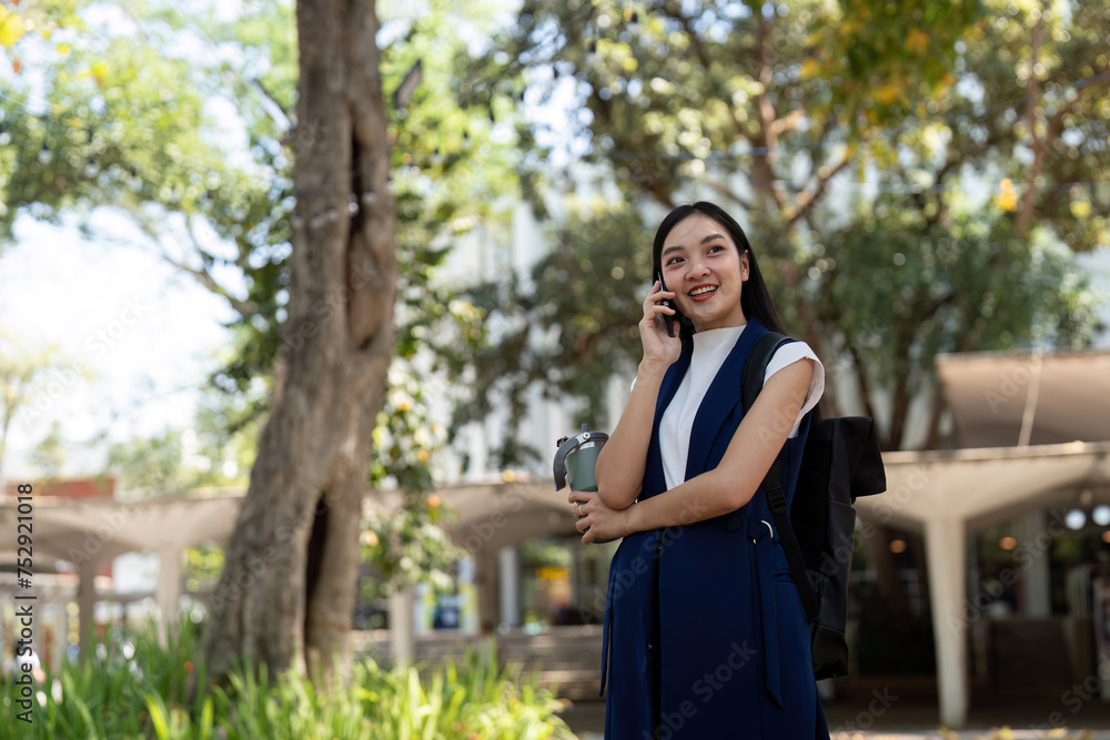 Young happy Asian business woman office professional talk cellphone in walking on city go work Young happy Asian business woman office professional talk cellphone in walking on city go work