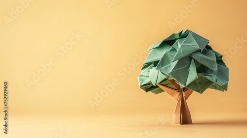 Arbol hecho con papel técnica origami sobre fondo naranja photo