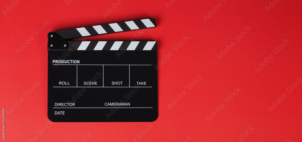 Clapper board or movie slate on red background..
