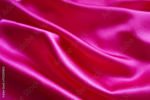 Pink silk or satin background, wavy, elegant and elegant. Close-up, background. Space for designblur or blurry