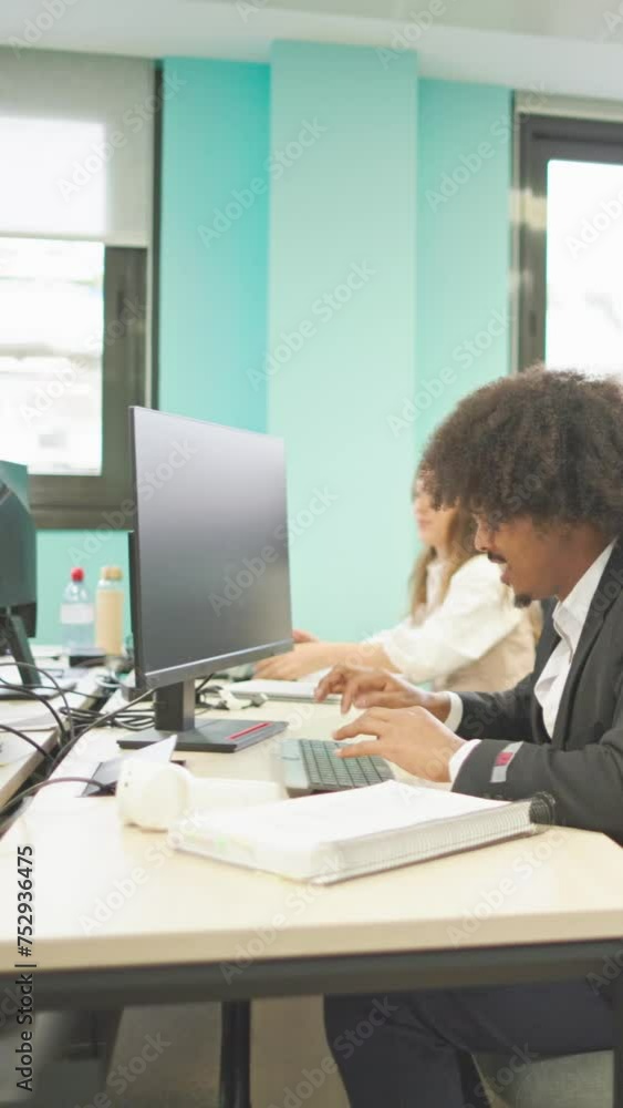 Vertical Slow motion video of a multiracial group of office workers enjoying and laughing in the office Vertical Slow motion video of a multiracial group of office workers enjoying and laughing in the office