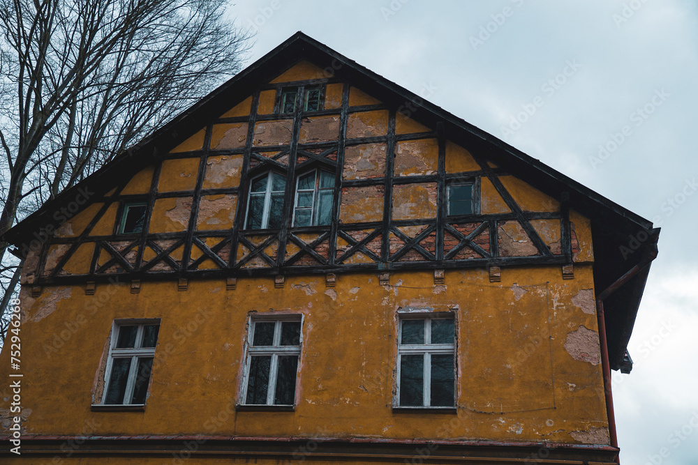 Old Yellow Building With Black Trim and Windows Old Yellow Building With Black Trim and Windows