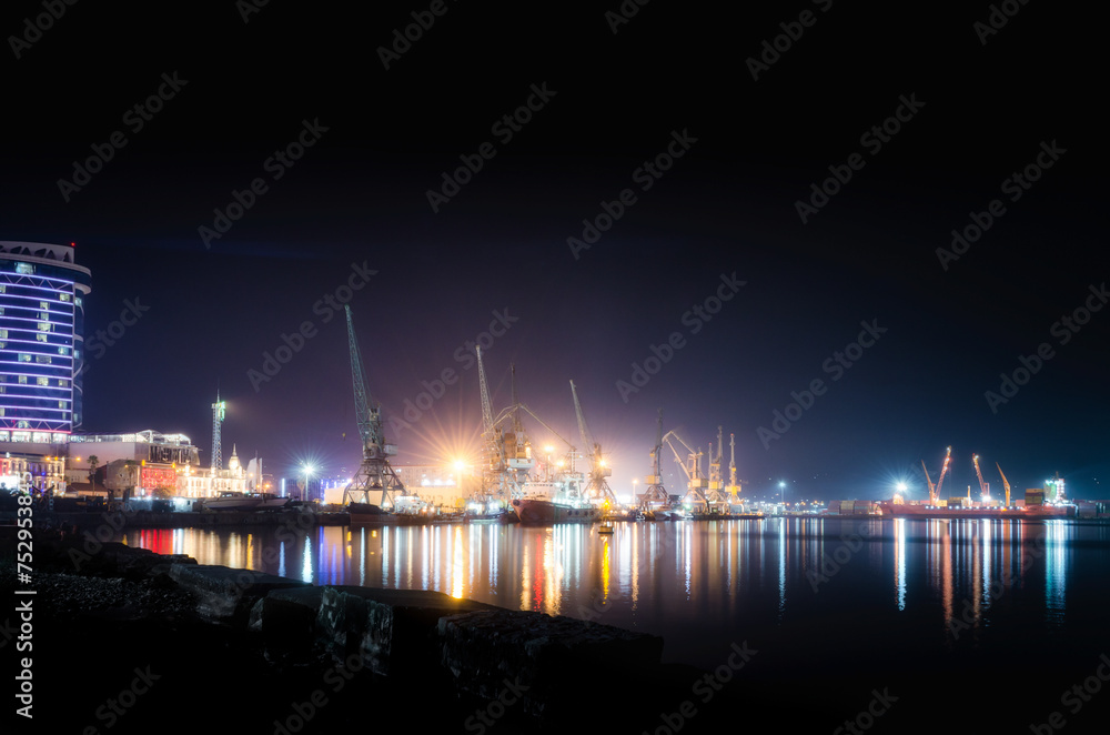 sea ​​port with ships and barges in Batumi at night