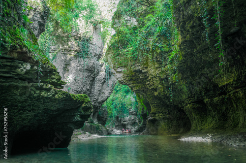 mountain river and tourists in a boat in a canyon in Georgia