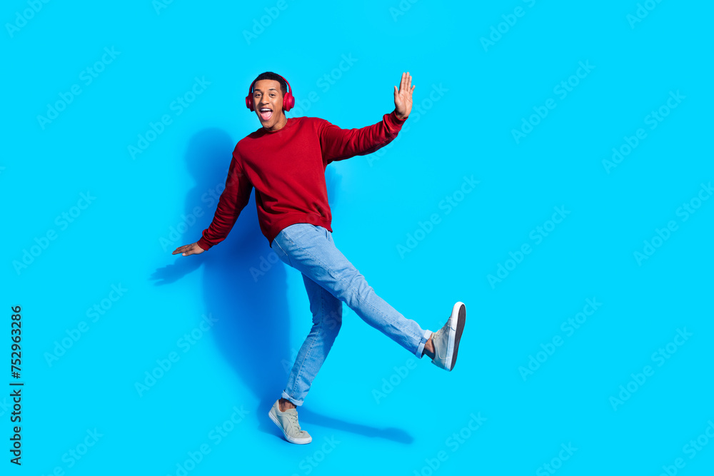 Photo of positive nice good mood man wear red trendy pullover listen upbeat music club disco isolated on blue color background