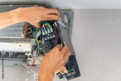 Technician checked air conditioning control board, Repairman fixed air conditioning systems, Technician man service repair and maintenance of air conditioners