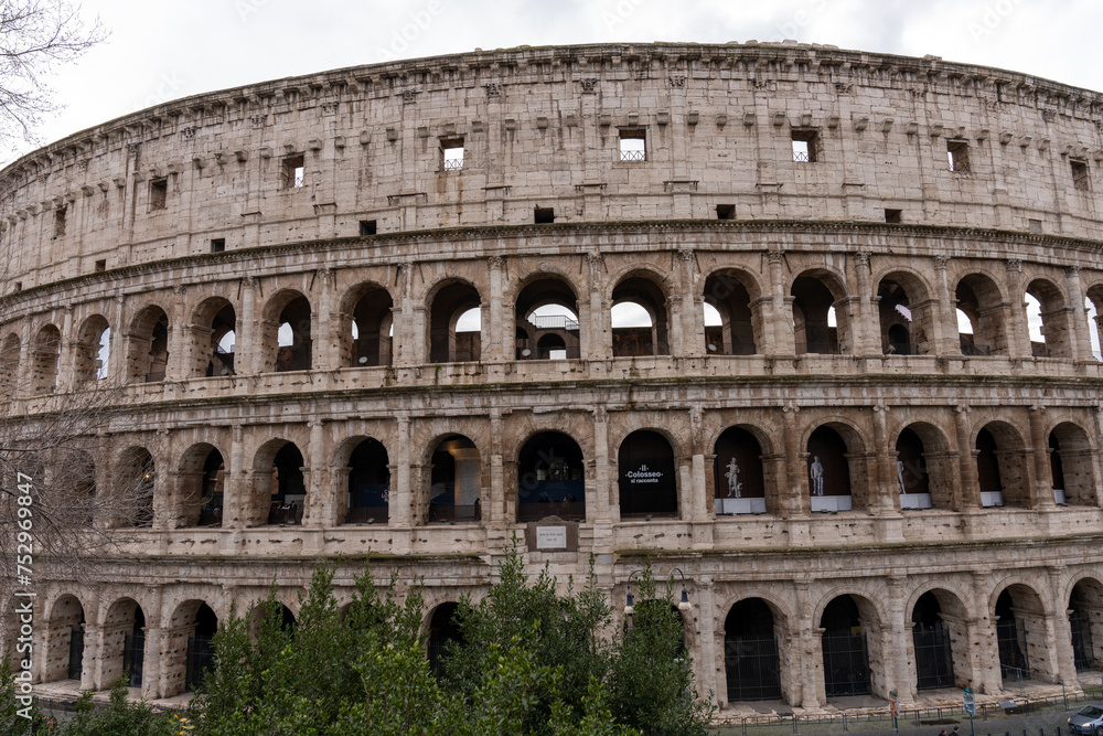 The Colosseum is a large, ancient building with many arched windows