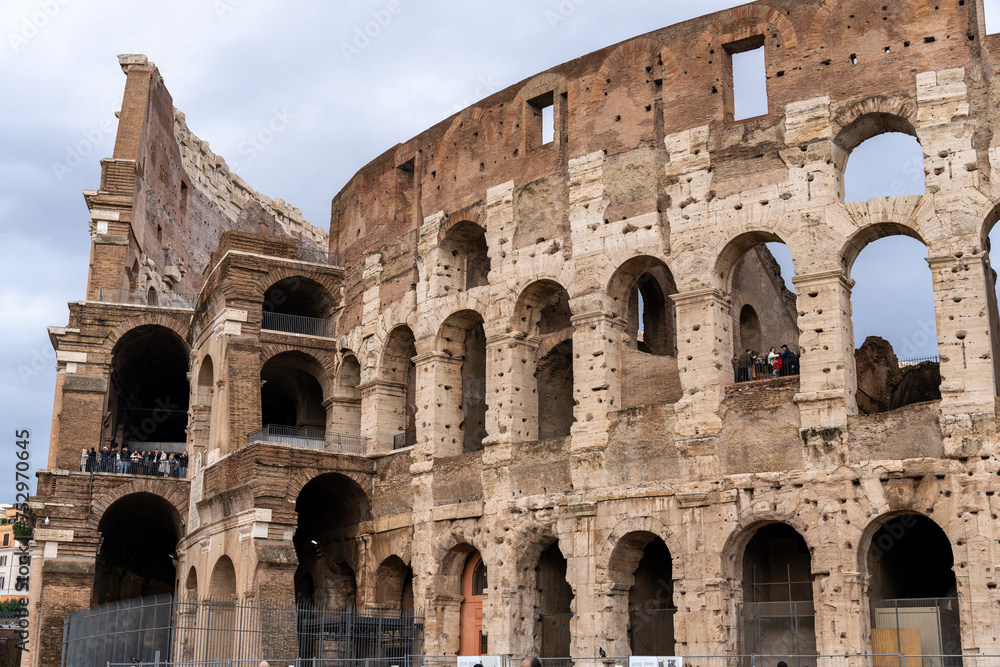 The Colosseum is a large, ancient building with many arches