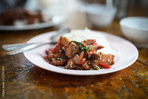 Close up and selective focus stir-fried crispy pork belly and basil with rice - Asian local street food style
