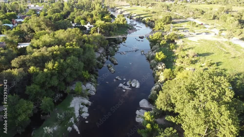 View of the river. Moving aerial view of a river with transparent waters with stones and vegetation on its banks and people bathing in it. Aerial landscape with drone of the Panaholma River in summer View of the river. Moving aerial view of a river with transparent waters with stones and vegetation on its banks and people bathing in it. Aerial landscape with drone of the Panaholma River in summer