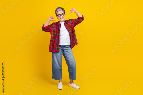 Full size portrait of cool positive grandmother point fingers self herself empty space ad isolated on yellow color background