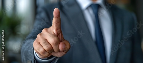 Pointing Businessman in Suit with Determination and Focus, To convey a strong message of leadership, communication, and decision-making in a photo