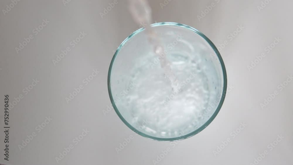 Sparkling Water being poured into a Still Glass showing Bubbles and Fizz Sparkling Water being poured into a Still Glass showing Bubbles and Fizz