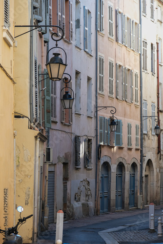 Romantic backstreet road alley in historic old town downtown Toulon, France with Mediterranean style house building facades and old little piazzas fountains picturesque city scenery	