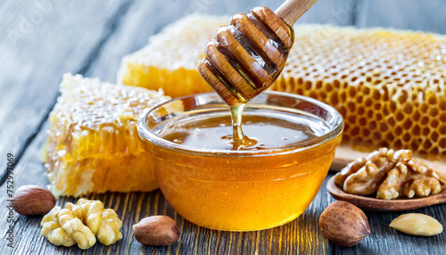 Assortment of honey products honeycombs, nuts in honey, beeswax in table. Healthy organic honey dipping in jar, closeup. Honey pouring in glass bowl
