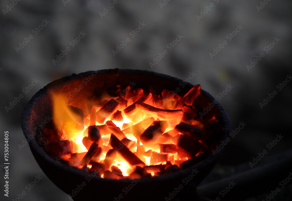 A photograph of a fire flaming with charcoal.