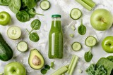 Bottle of green smoothie surrounded by green fruit and vegetables: apples, avocado, spinach, celery, cucumber on white simple background top view. 