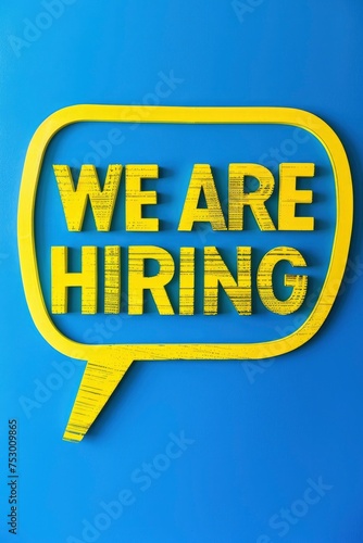 Vibrant Job Opportunity, WE ARE HIRING Bold Yellow Cutout Letters on Speech Bubble Against Blue Background © ABDULHAMID
