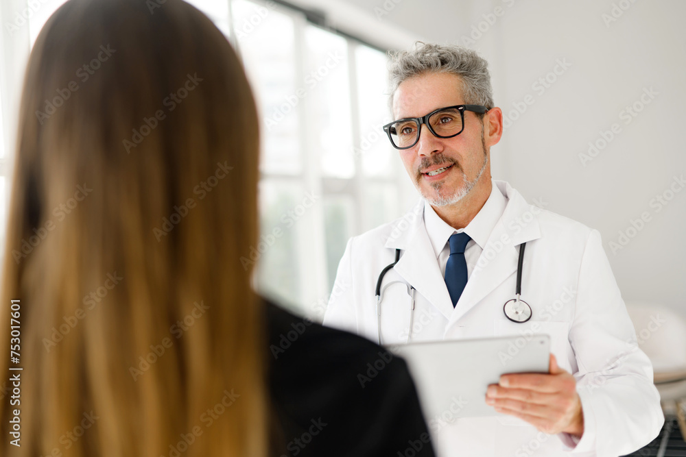 Senior doctor is shown in mid-conversation with a patient, highlighting the interactive and compassionate aspect of medical care. The importance of good communication in healthcare. Senior doctor is shown in mid-conversation with a patient, highlighting the interactive and compassionate aspect of medical care. The importance of good communication in healthcare.