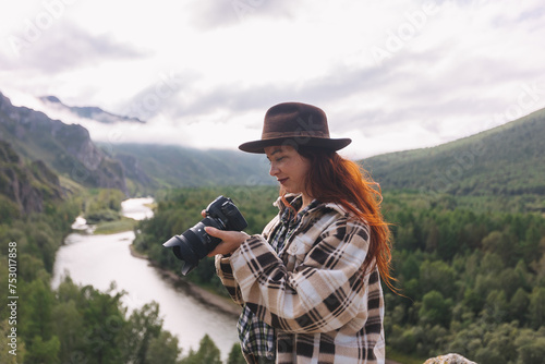 Landscape photographer a woman adjusts the camera while shooting mountains in Khakassia. The concept of freelancing, travel