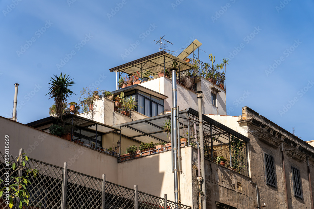 A building with a rooftop garden and a balcony A building with a rooftop garden and a balcony