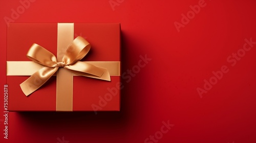 Gift box with gold ribbon on red background. Shiny package valentine day present, christmas and anniversary celebration, Christmas Gift © Dm