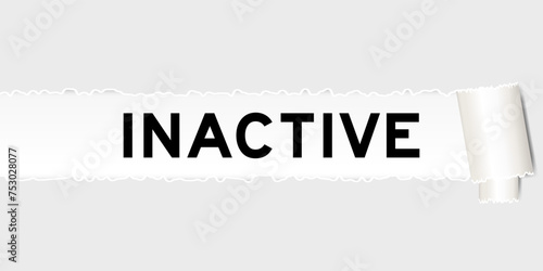 Ripped gray paper background that have word inactive under torn part