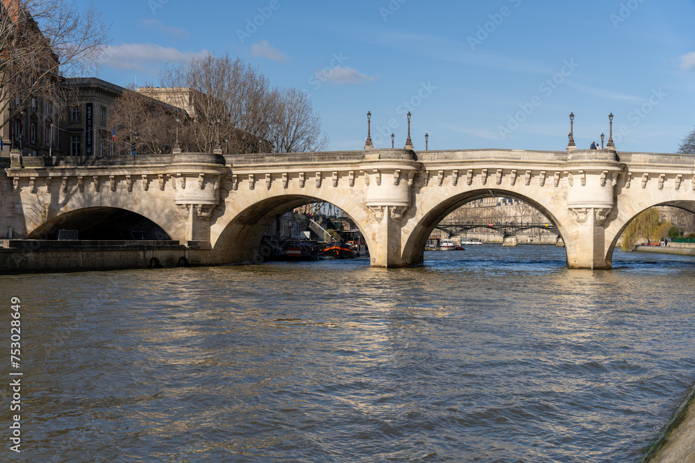 A bridge spans a river with boats on it