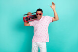 Photo of nice overjoyed person have good mood carry boombox dancing isolated on teal color background