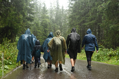 Tourists in raincoats in the mountains