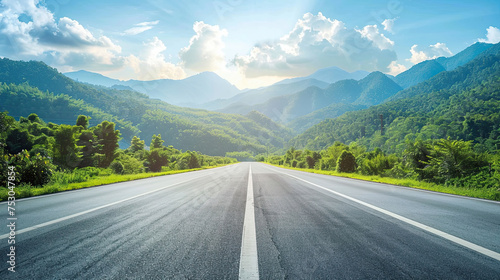 Asphalt highway road and mountain nature landscape under blue sky.