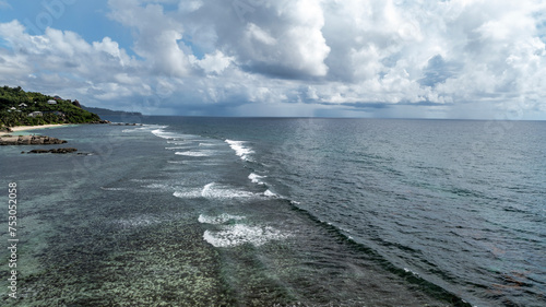 panoramic view from a drone of the sea bays and beaches on a sunny day of the Seychelles islands