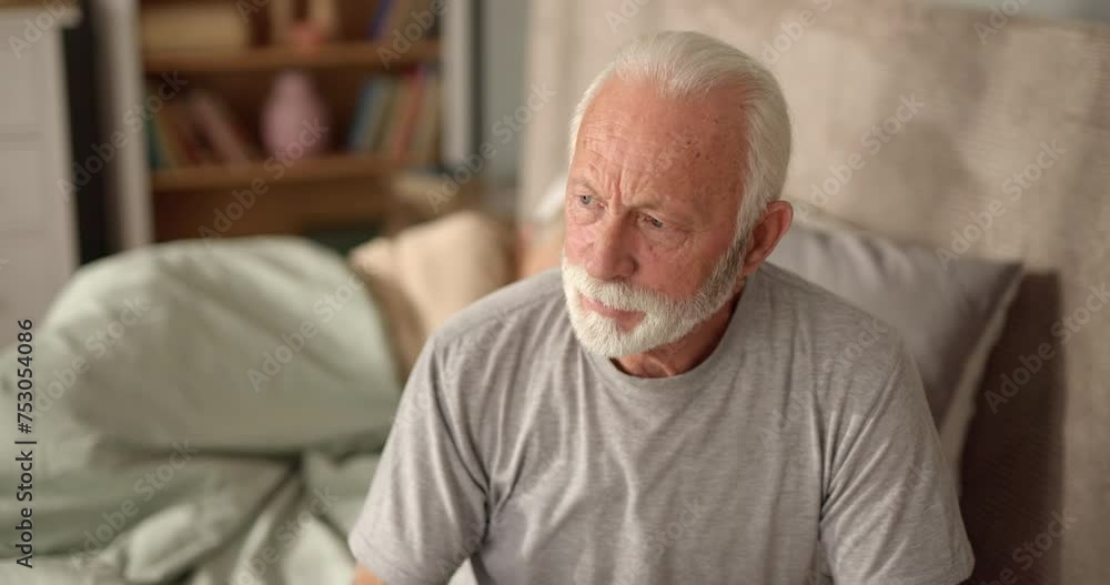 Elderly man drinking a glass of water in bed Elderly man drinking a glass of water in bed