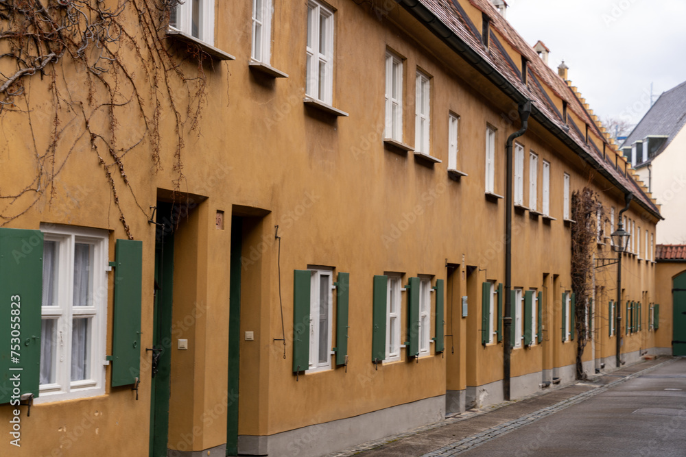 A row of brown buildings with green shutters