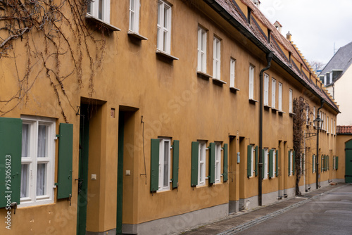 A row of brown buildings with green shutters