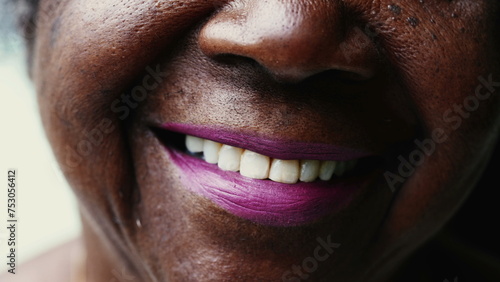 Macro close-up of a happy Senior black woman smiling at camera with wrinkled face showing wisdom and old age. Portrait of an African American lady in her 80s