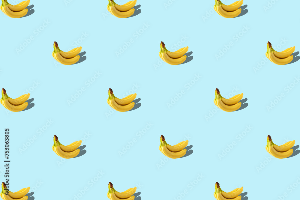 Trendy summer pattern with banana on bright blue background. Minimal summer concept.