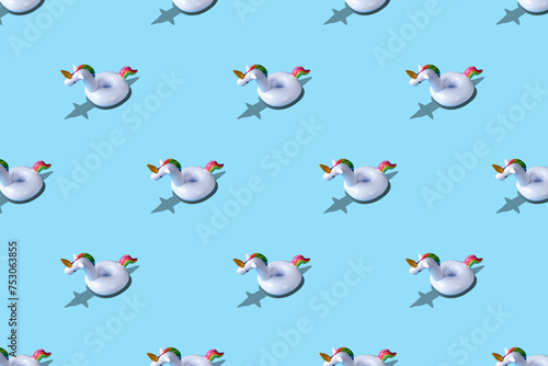 Inflatable unicorn pool toy pattern on blue background. Minimal summer concept.