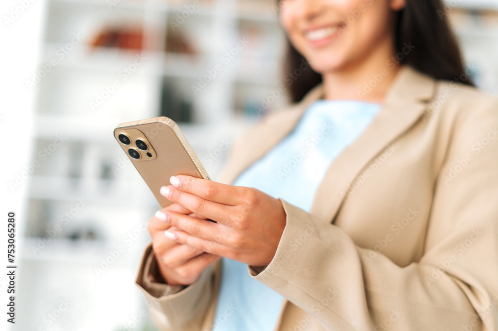Using gadgets. Close-up of female hands, holding smart phone, texting in social media with friends or clients, making online order or goods delivery, typing text, browsing information in internet Using gadgets. Close-up of female hands, holding smart phone, texting in social media with friends or clients, making online order or goods delivery, typing text, browsing information in internet