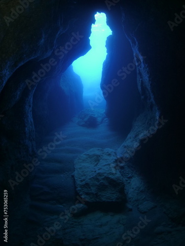 cave diving underwater scuba divers exploring caves and having fun ocean scenery sun beams and rays background