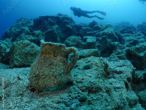 scuba diver underwater exploring ancient amphoras deep water history search ocean scenery