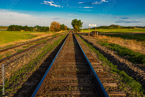 Railroad tracks leading into the vast green landscape of central North Dakota.