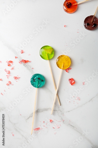  Top view of fruits pop candy lollipop on light surface