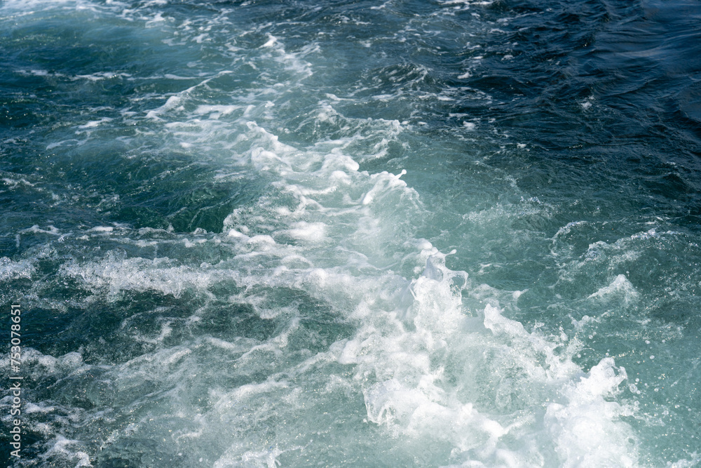 The water is blue and white with a lot of waves