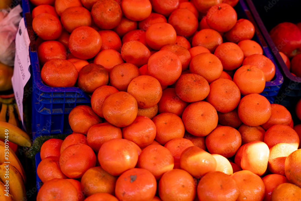 A crate of oranges is piled on top of another crate of oranges