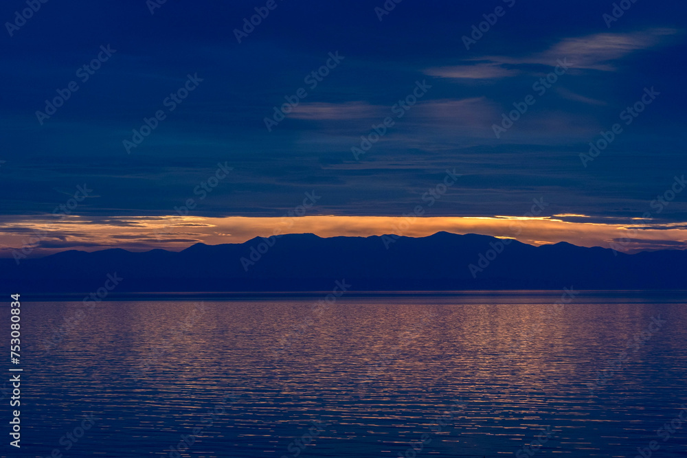 Fototapeta premium Serenity at sundown. Captivating reflections in the Aegean sea.