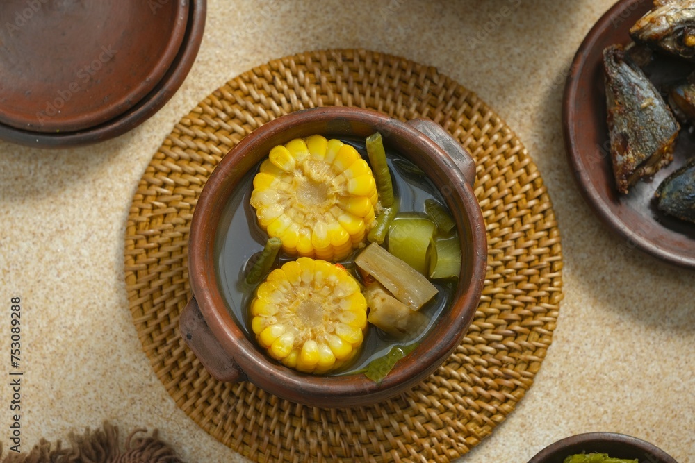 Sayur asem in bowl, traditional food from javai. It is tamarind soup with ingredient slices of chayote, corn, tamarind, long beans, chili pepper Sayur asem in bowl, traditional food from javai. It is tamarind soup with ingredient slices of chayote, corn, tamarind, long beans, chili pepper