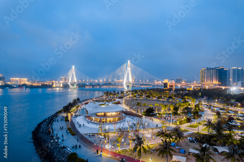 Night view aerial photography of Yundong Library and Century Bridge in Haikou, Hainan, China