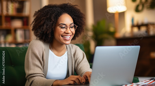 Close up portrait of young beautiful woman smiling while working with laptop in office.