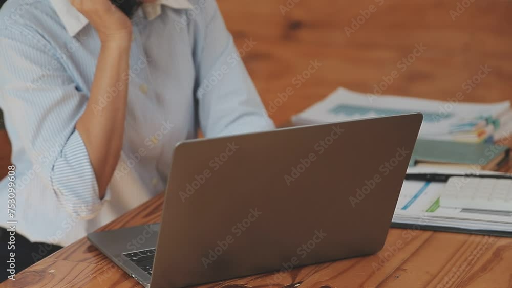 Asian Businesswoman Using laptop computer and working at office with calculator document on desk, doing planning analyzing the financial report, business plan investment, finance analysis concept. Asian Businesswoman Using laptop computer and working at office with calculator document on desk, doing planning analyzing the financial report, business plan investment, finance analysis concept.